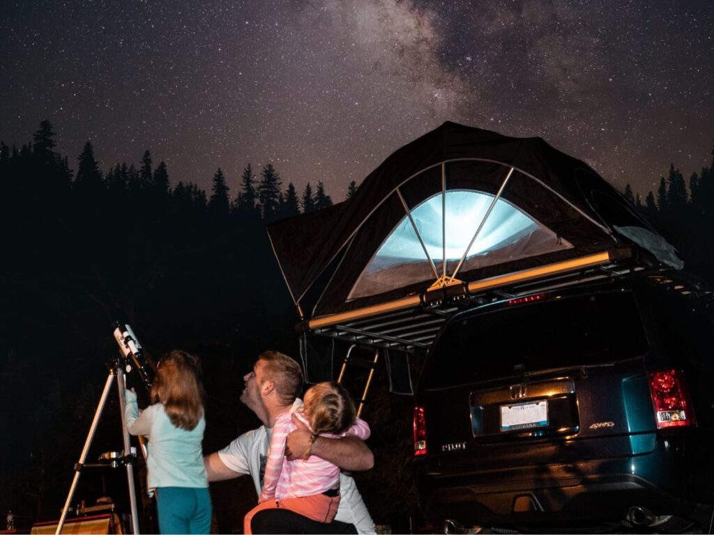 girls and their father stargazing