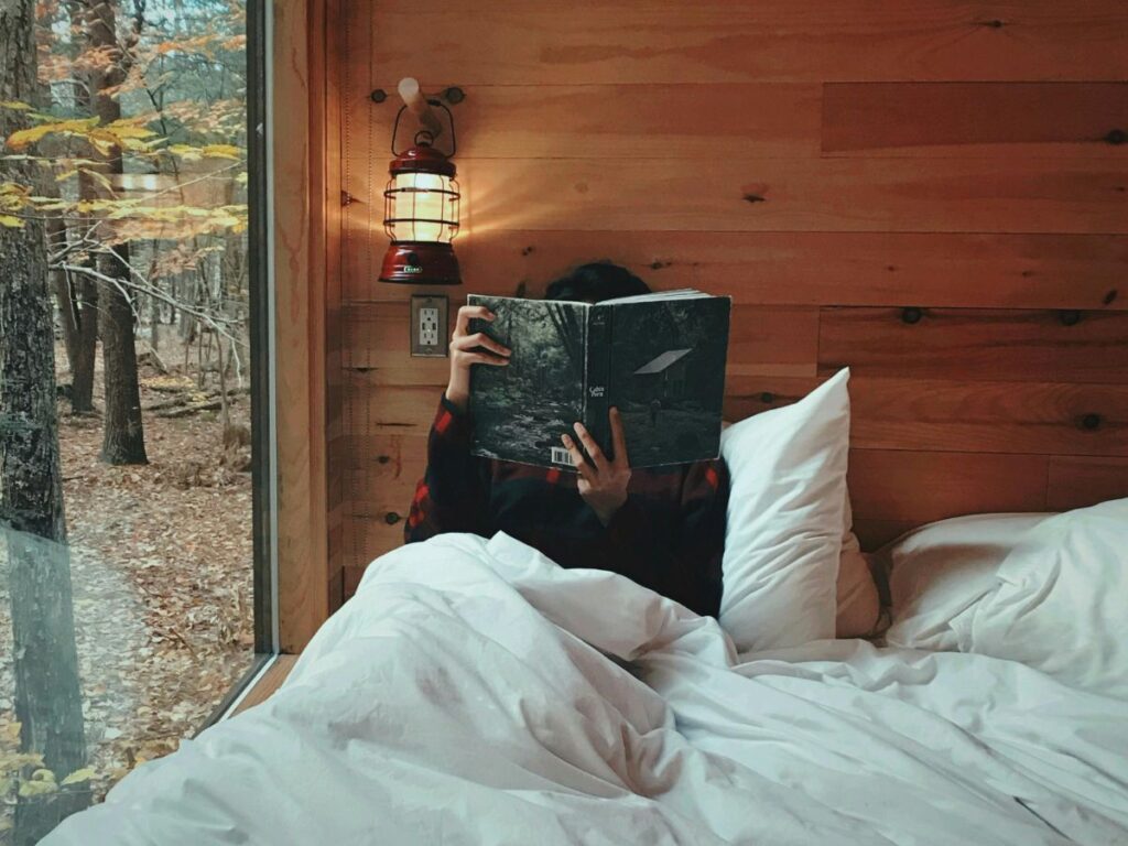 woman reading a book in her cabin rental